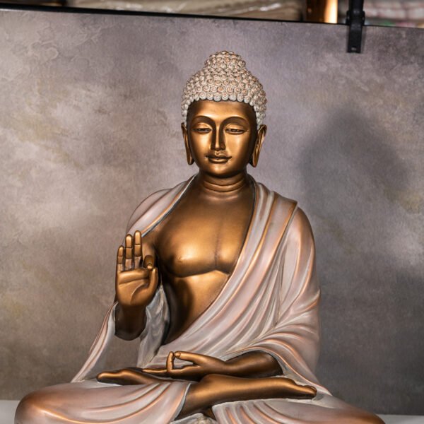 Serene Meditating Buddha Statue in Abhaya Mudra, Symbolizing Peace, Protection, and the Dispelling of Fear, with a Gilded Bronze Finish and Intricate Usnisha Detail.