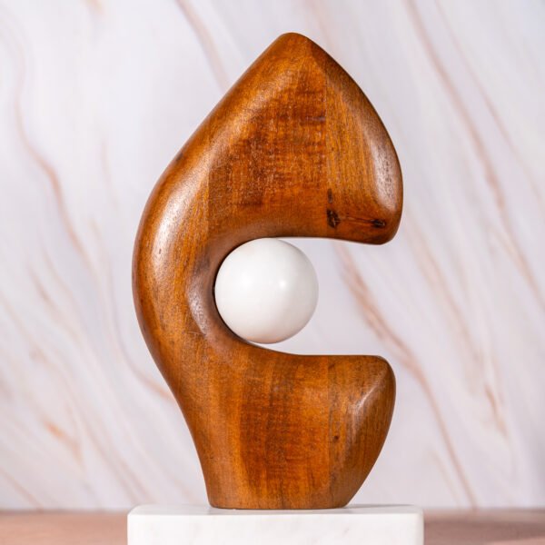 Abstract Wooden Sculpture with Embedded White Sphere on a Rectangular White Base, Showcasing Organic Curves and Smooth Textures.