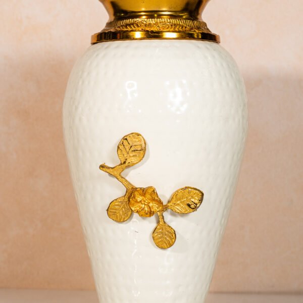 Elegant White Ceramic Decorative Vase with Golden Floral Embellishment and Ornate Brass Top, perfect for sophisticated home decor.
