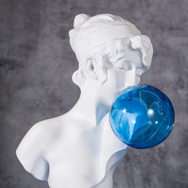 A Marble Bust Blowing a Shimmering,Faceted Blue Bubble,Bridging Ancient Artistry and Contemporary Playfulness