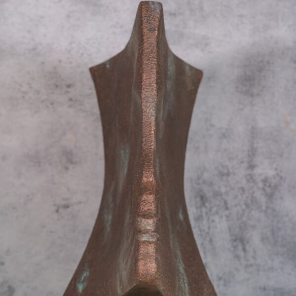 A Sculptural Study of Form and Texture with an Oxidized Copper Patina and a Central Polished Spine