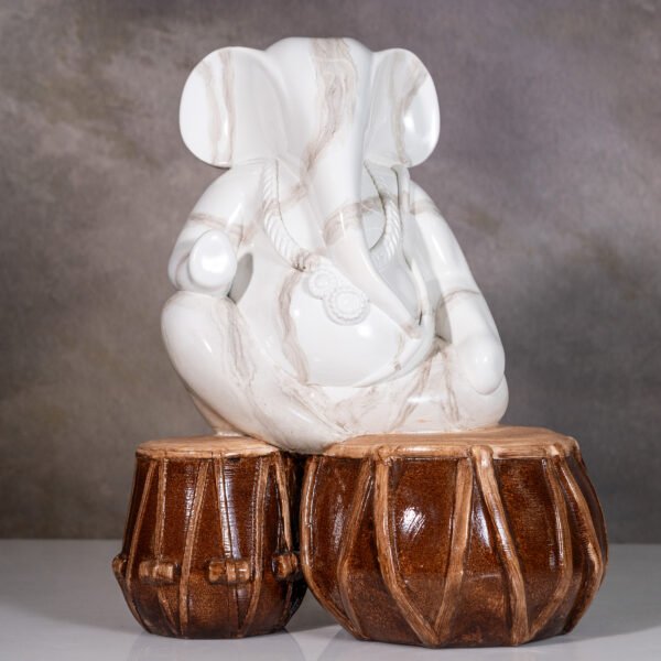 Serene White Ganesha Idol Seated Upon Traditional Indian Tabla Drums